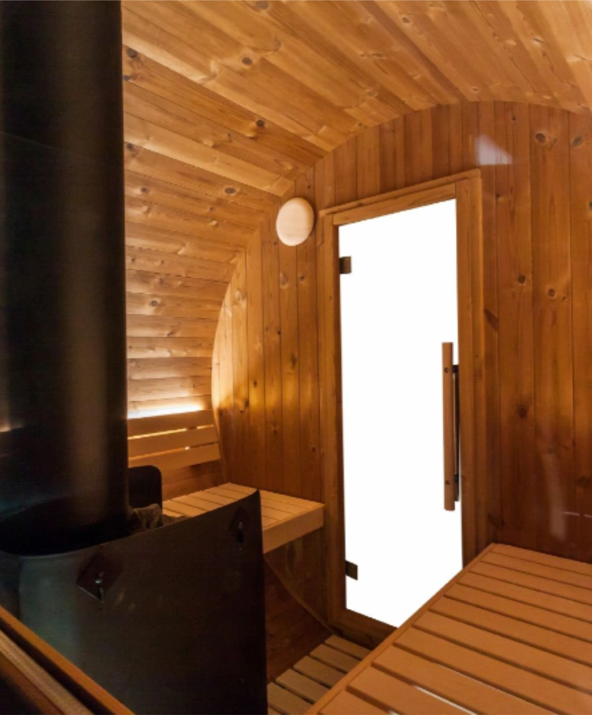 Harvia Kaski 240 Panorama barrel sauna interior with wood-burning heater