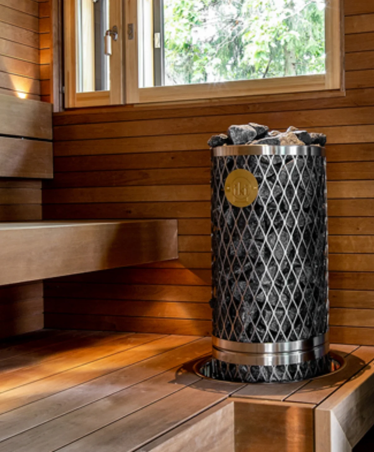 IKI pillar electric sauna heater installed beside wooden benches