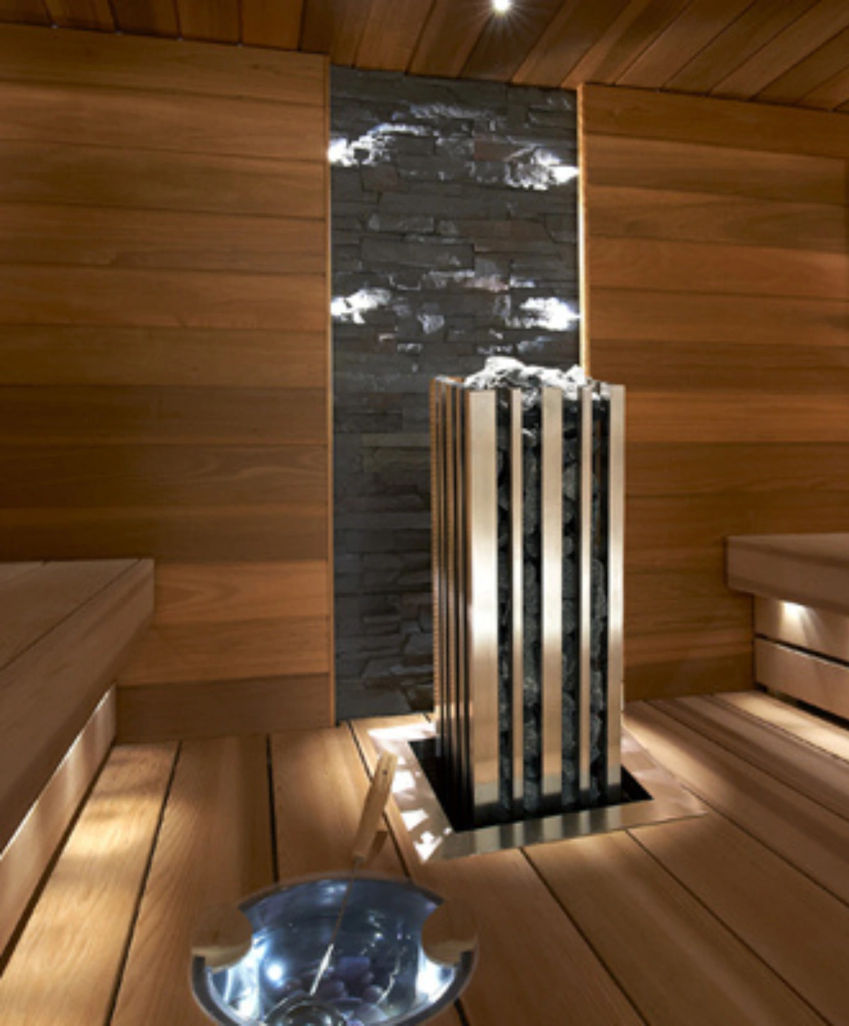 IKI electric sauna heater installed in a wood-lined sauna
