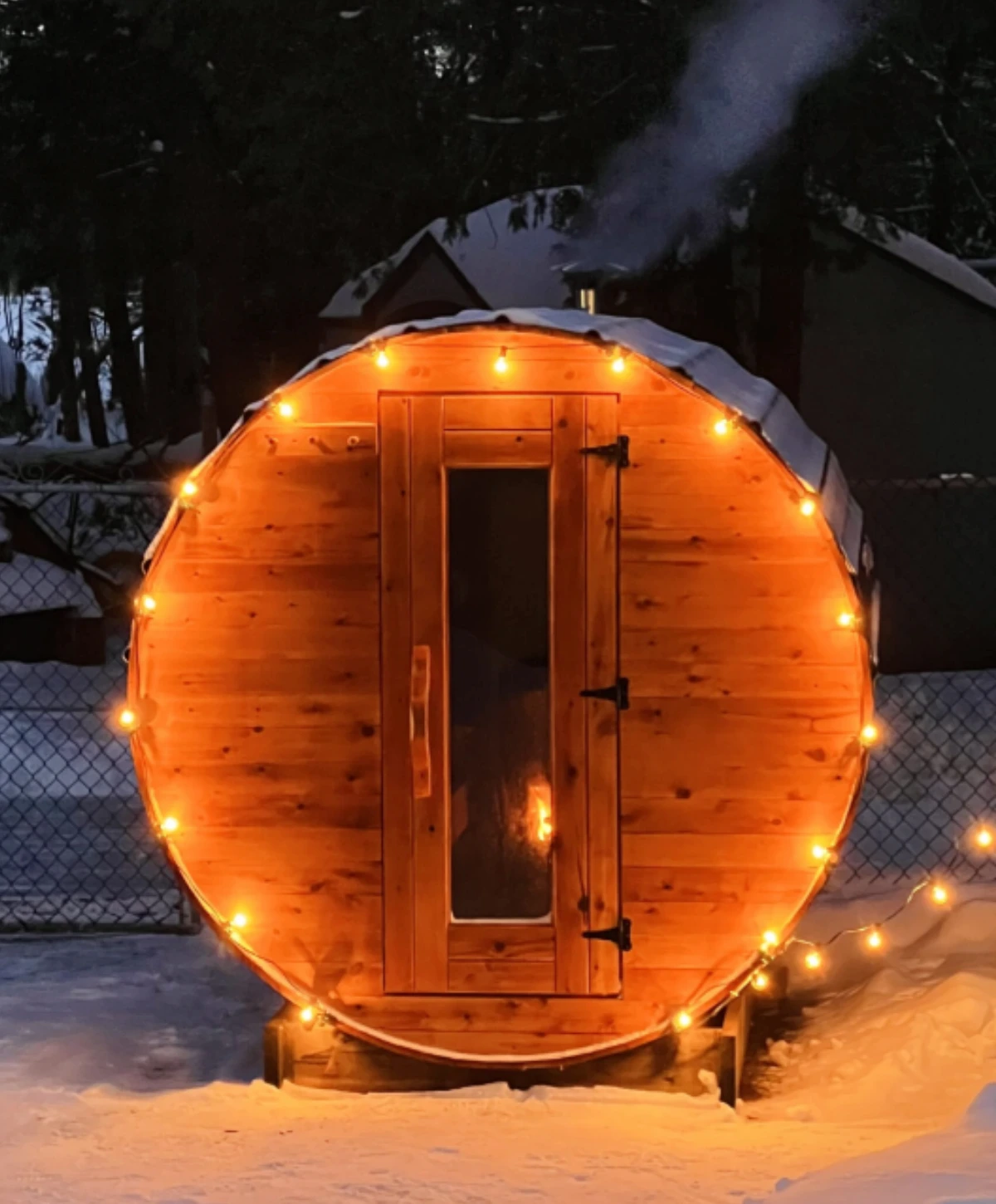 SaunaSpa.Ca Barrel Sauna with Changing Room in a snowy outdoor setting