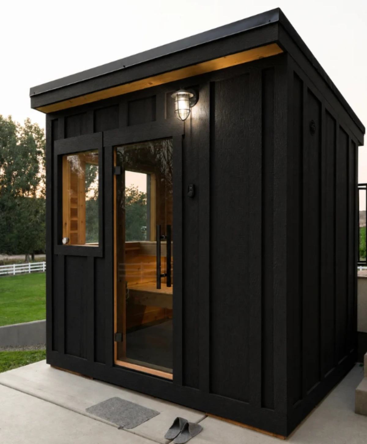 Sweat Kingdom The Outpost outdoor sauna with black exterior and cedar interior