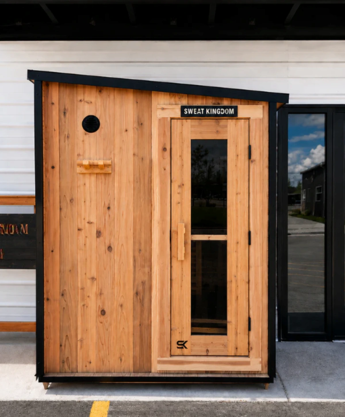 Sweat Kingdom Summit outdoor sauna with cedar exterior and black roof